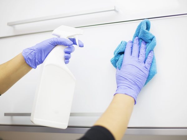 Woman at work, professional maid cleaning in office against virus desease